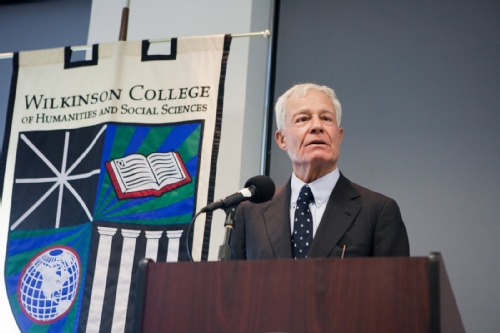 Man at podium speaking.