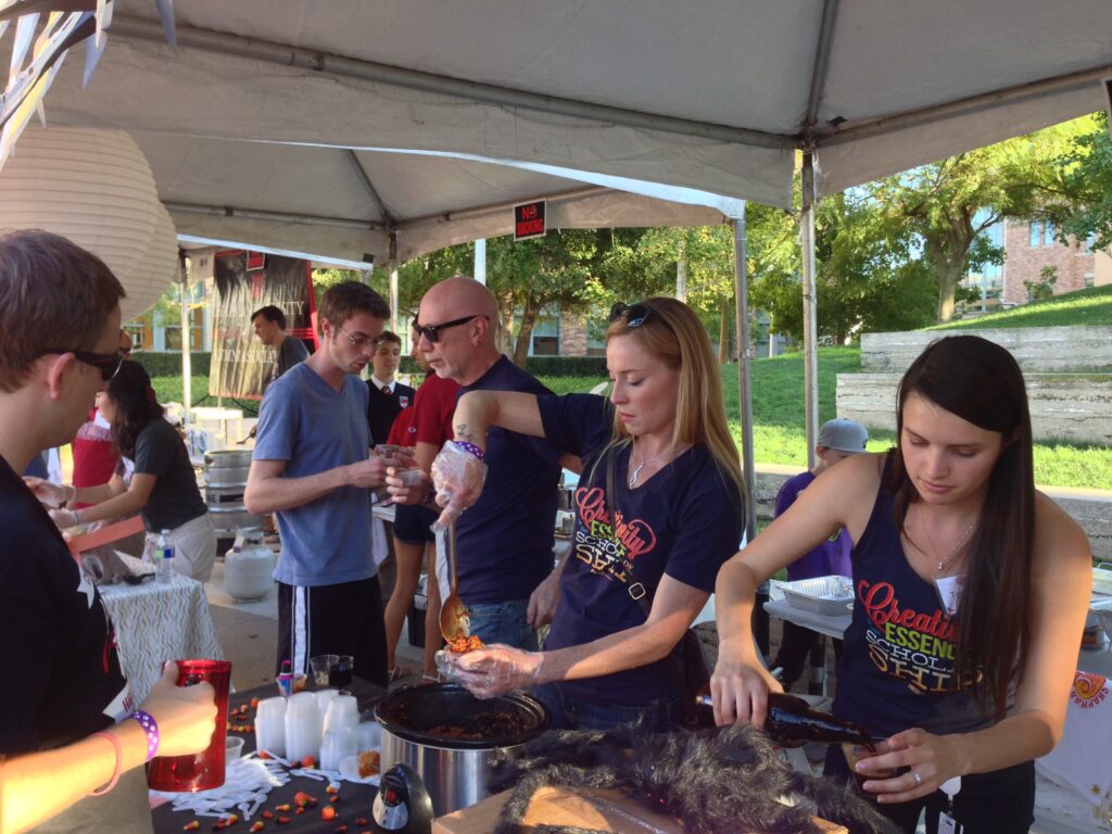 People participating in stew and brew booth.