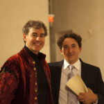 Two men smiling.