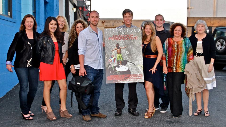 Group of people smiling with poster.