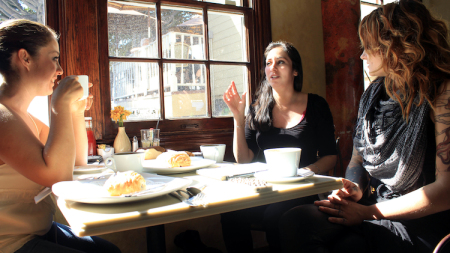 Three women talking in cafe.
