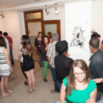 People talking in art gallery.