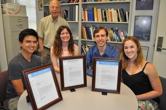 Group of people smiling with awards.