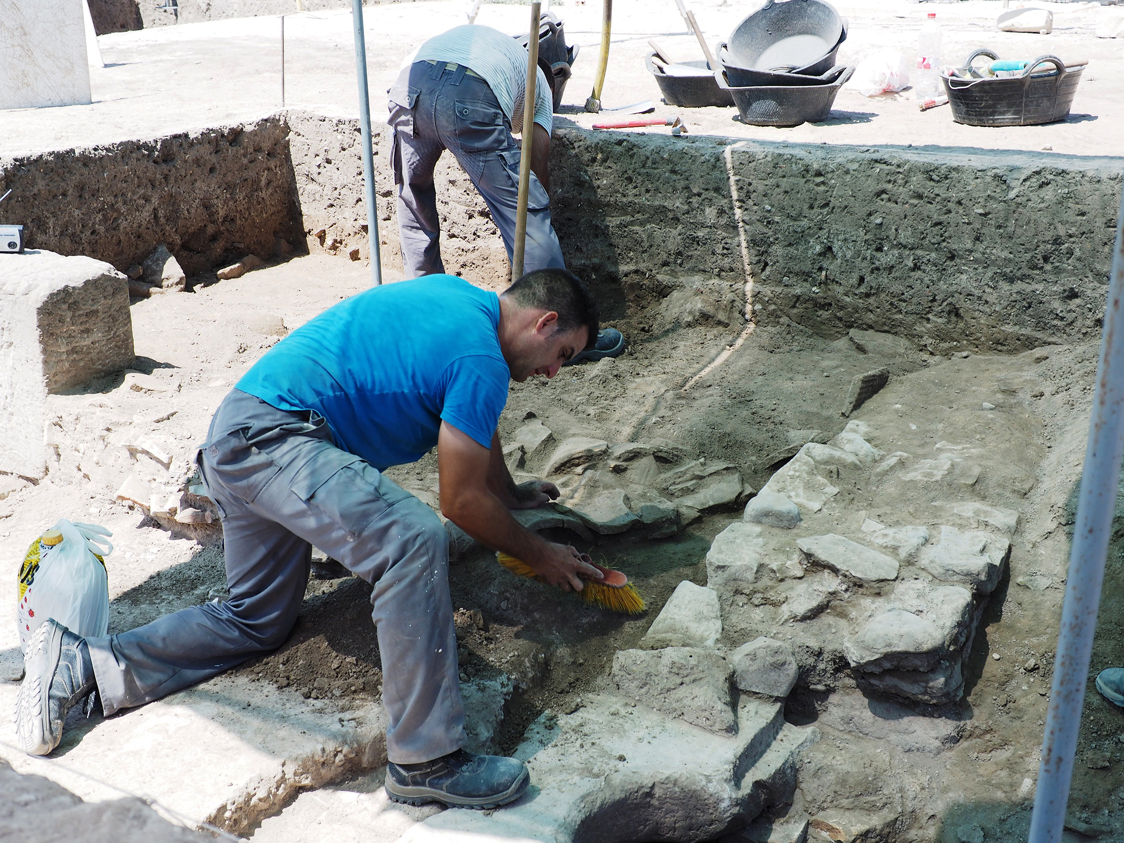 People working at dig site.