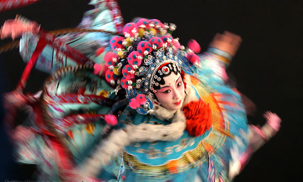 Woman in traditional Chinese clothing dancing.