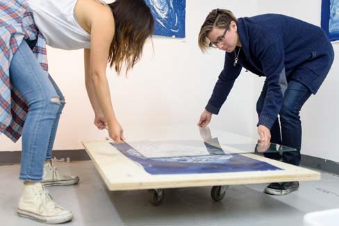 Two women creating art.