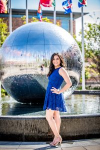 young woman standing in front of a large water ball