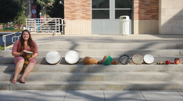 student with many different drums