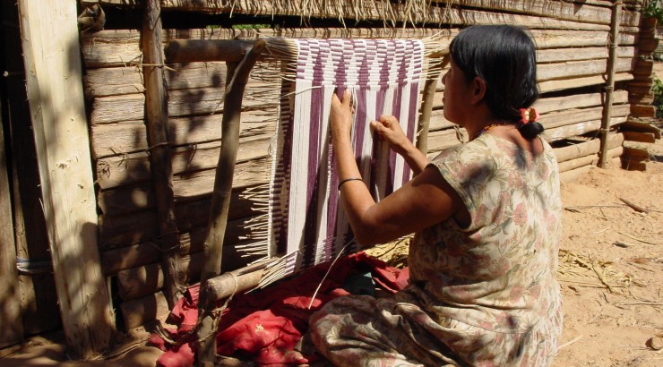 woman hand weaving a rug