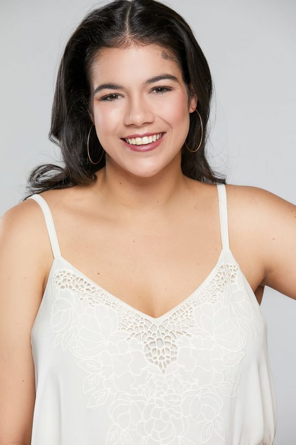 young smiling Latina in off-white camisole top