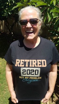 smiling woman in sunglasses and dark t-shirt that reads retired 2020 not my problem anymore