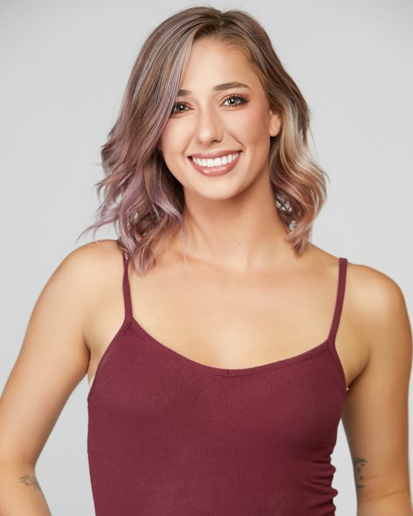 young smiling Caucasian woman in burgundy camisole top