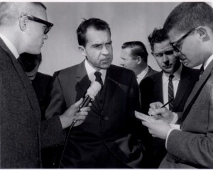 Group of people interviewing Richard Nixon.
