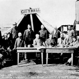 Historical photo of group of men outside City Hall tent