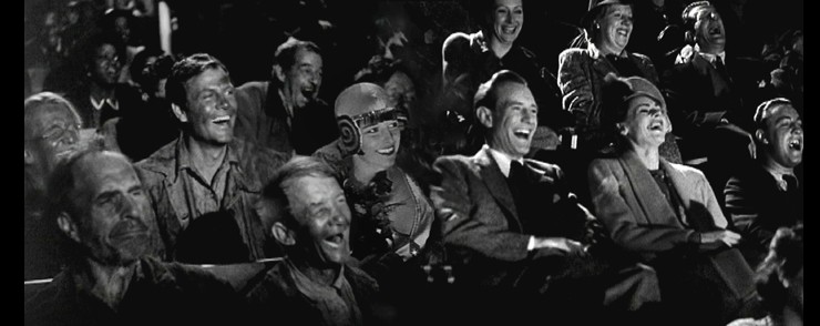Still of people laughing in an audience