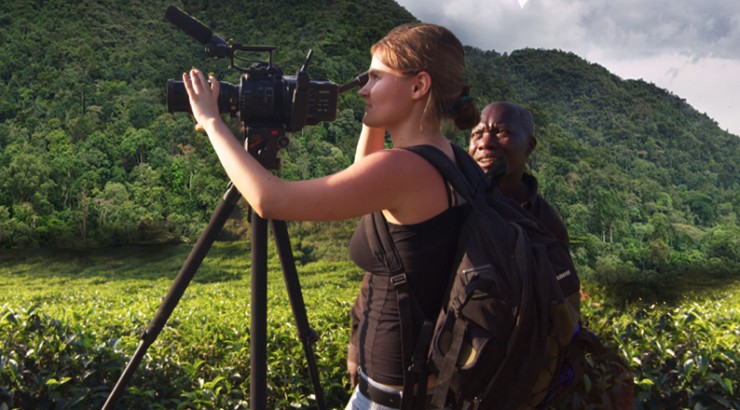 student framing camera in tropical landscape