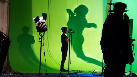 The shadow of a Sandtrooper collides with Wire Rig assistant Luke Couce on the green screen stage
