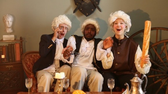three colonial men sitting around in comedy sketch