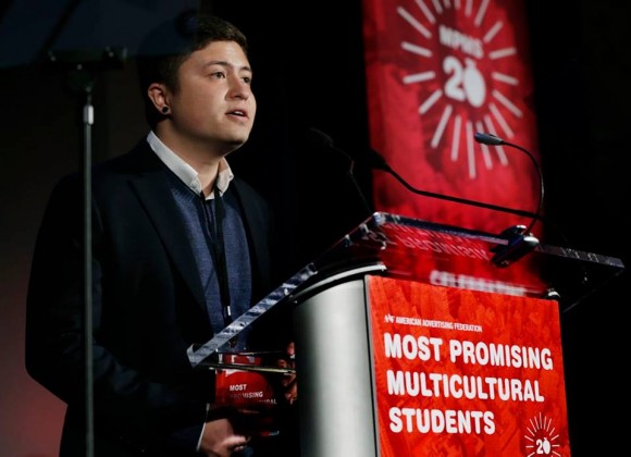 man standing at a podium that says most promising multicultural students