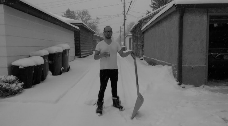dan olson standing in the snow with shovel
