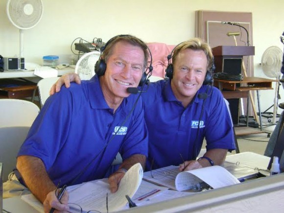 two men wearing headsets looking at camera and smiling