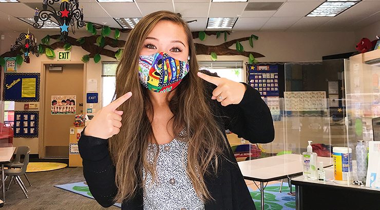 Alina Bitter (MACI '21) wear a face covering in an elementary school classroom