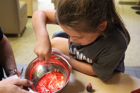Young girl makes silly putty