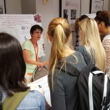 Melissa Rowland-Goldsmith explains her research to a group of enthralled students.