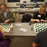 Chess tournament attendees face off in the first round of the tournament.