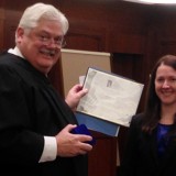 Ali Bollbach receiving Excellence Award from judge