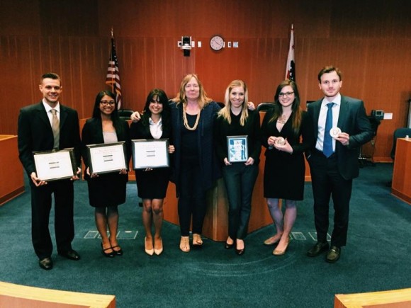 Student holding awards at national moot court