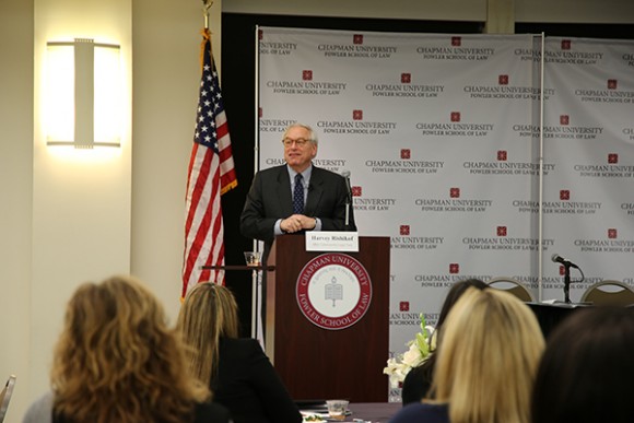 Henry Rishikof speaking at a podium at Law Review Symposium