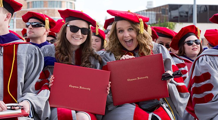 2016 graduates hold up diplomas