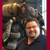 Jack Anderson with a larger than life statue of ‘Grommash Hellscream’ from World of Warcraft at Blizzard HQ”