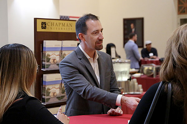 Nate Camuti shakes hands with prospective law students