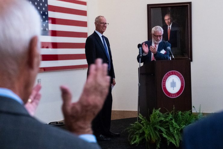 Photo of Parker S. Kennedy (center) being acknowledged by guests and President Daniele C. Struppa for his unprecedented gift of $15 million to Chapman Law School