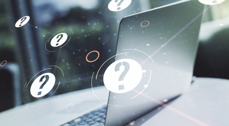 Laptop with question marks overlay