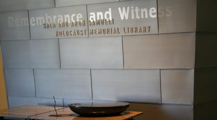 Samueli Memorial Library name over the water sculpture depicting a child's hands spilling water onto a small tree branch