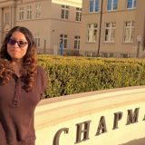 Briana Sitting on the Chapman Sign