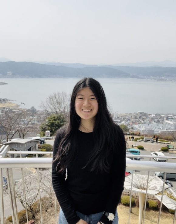 Emi traveling by the sea