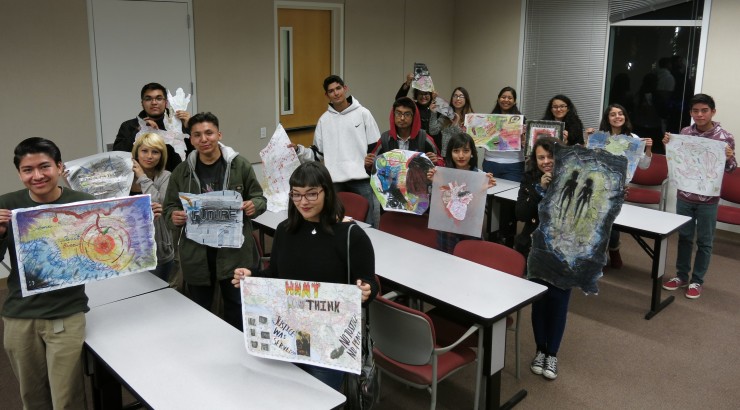 students holding artwork