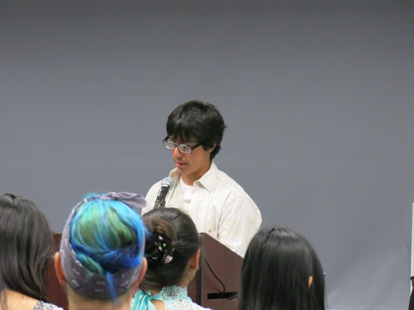 man speaking in front of an audience