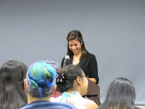 woman speaking in front of an audience