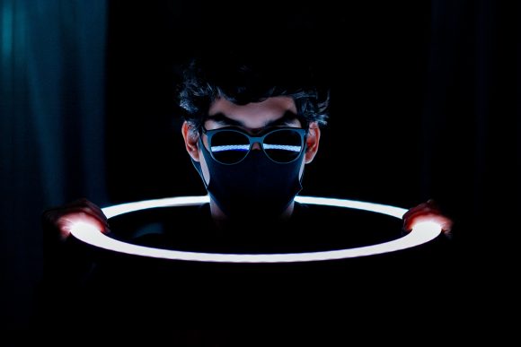 Masked Male Head through light hole with glasses