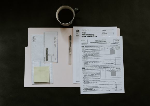 Image of tax documents and a cup of coffee