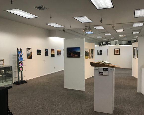 Photograph of several pieces of art displayed in an exhibit