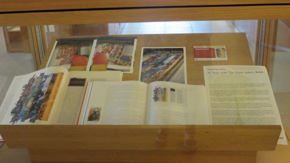 Open books, pamphlets, and flyers inside a display case