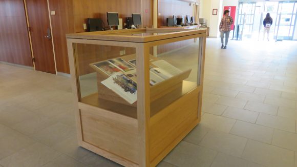A display case in a library lobby, with books inside