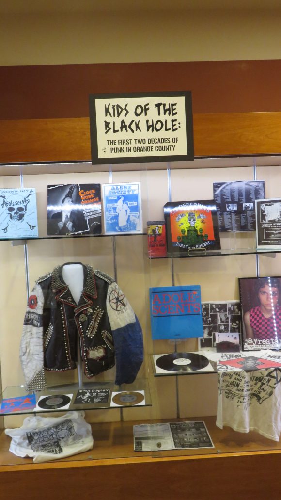 A cabinet filled with punk rock memorabilia