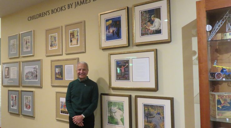 President Doti stands in front of the new Children's Books By James L. Doti wall
